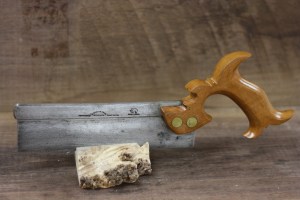 The saw he ISN'T using...